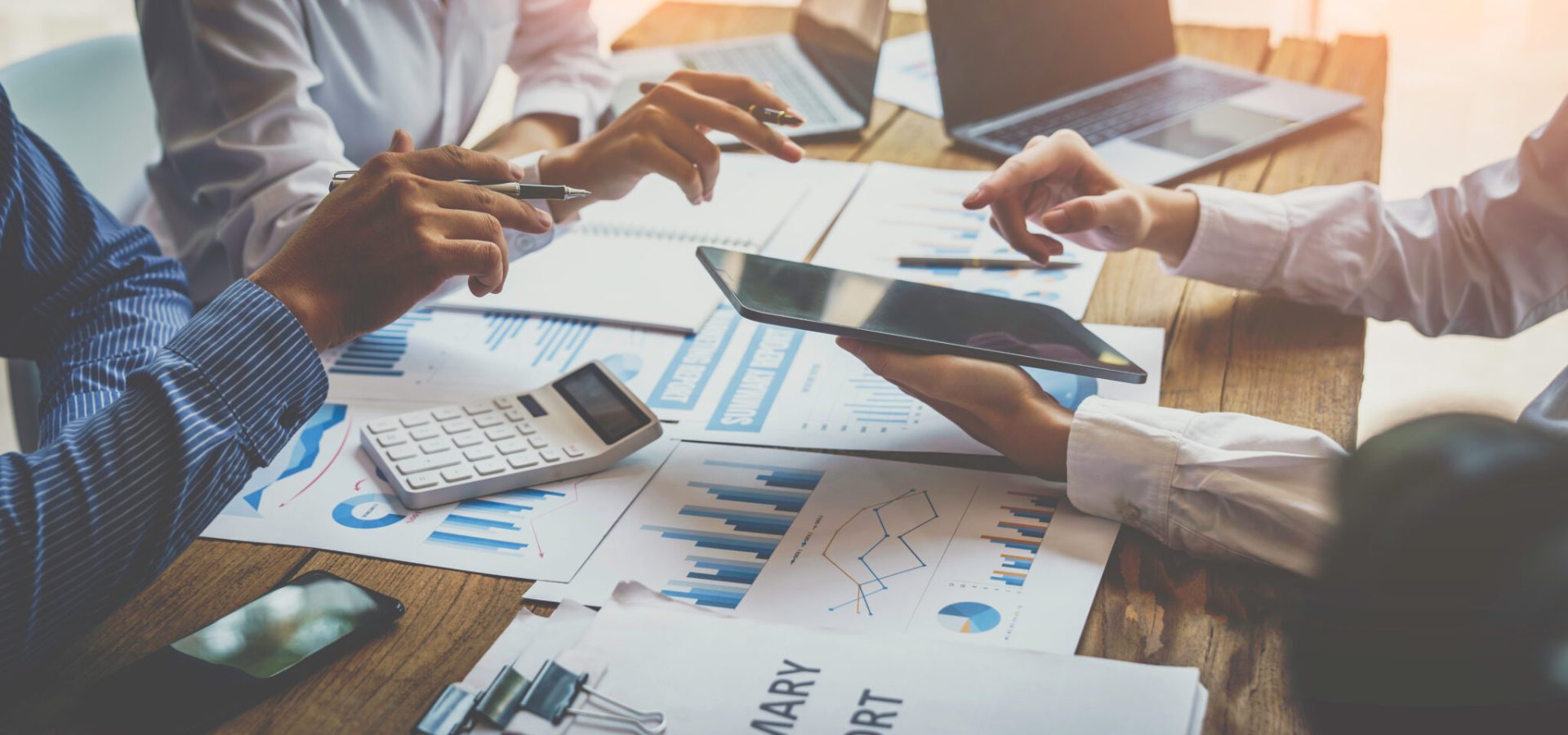 Financial analyst analysis business financial report on digital Financial analyst analysis business financial report on digital tablet during discussion at meeting of corporate showing the results of their successful teamwork., business meeting concept, Marketing